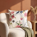 Multicolored thread embroidered cushion cover with floral motifs on white base