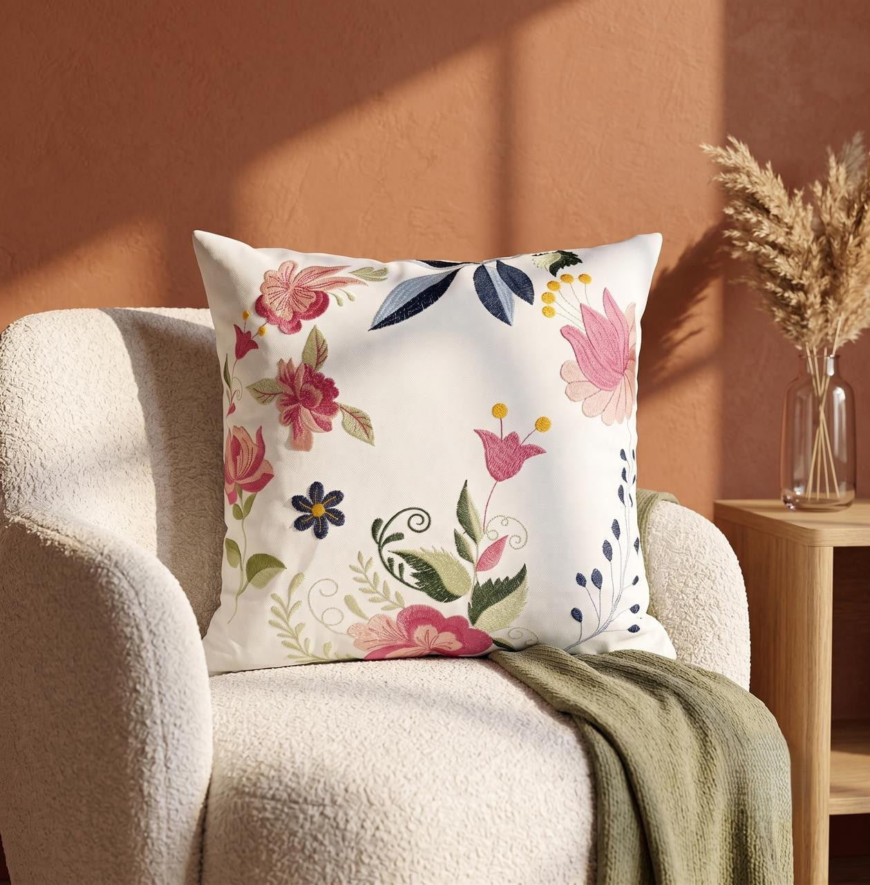 Multicolored thread embroidered cushion cover with floral motifs on white base